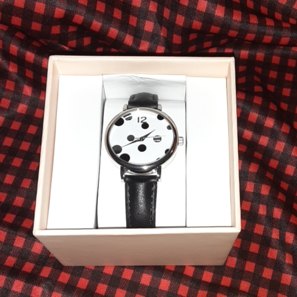 A black and silver polka dot watch